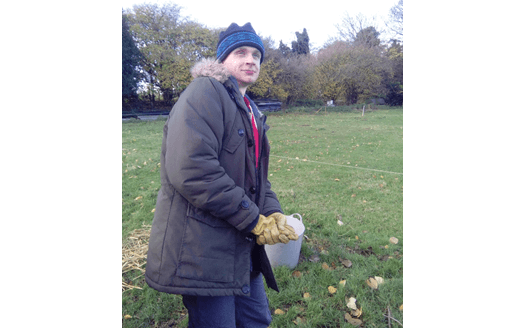 photo of K in field with hat on smiling